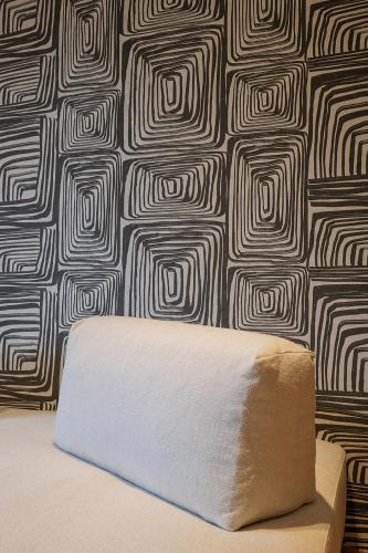 a mattress against a wall with a black and white wallpaper at Villa Amelia in Orta San Giulio