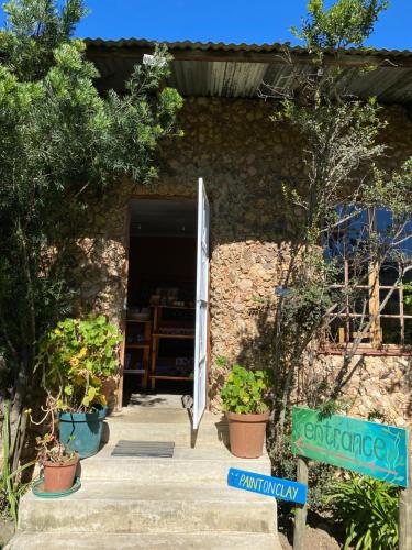 a doorway to a building with potted plants at Sani Lodge & Cottages in Sani Pass