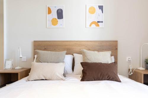 a bedroom with a bed with white sheets and pillows at Bext Valdebebas in Madrid