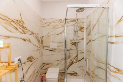 a bathroom with a shower and a toilet at Luxury Seaside Escape - Coralia in Marina San Vito