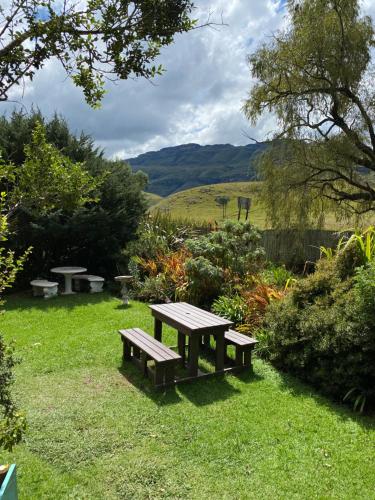a picnic table in the grass in a garden at Sani Lodge & Cottages in Sani Pass