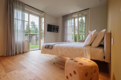 a bedroom with a bed and a large window at Villa Amelia in Orta San Giulio