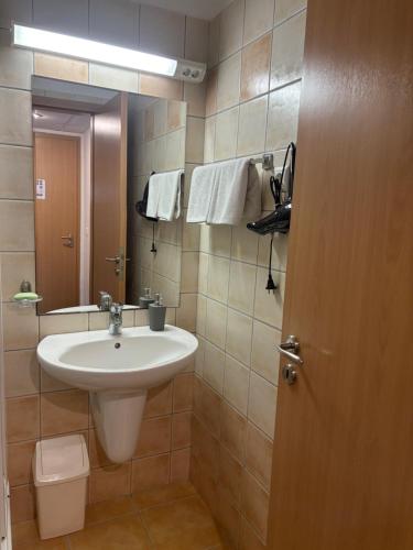 a bathroom with a sink and a mirror at Delfin Apartman Zalakaros in Zalakaros