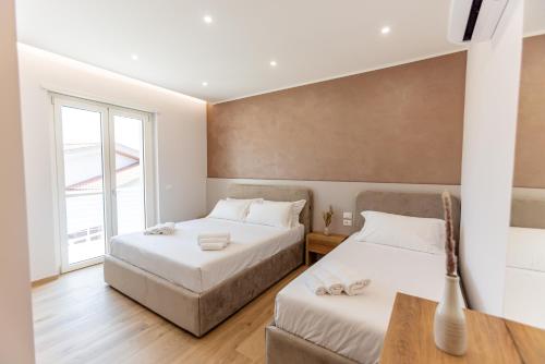 a bedroom with two beds and a window at Luxury Seaside Escape - Coralia in Marina San Vito