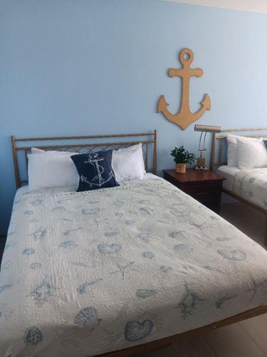 a bedroom with a bed with a blue wall at Beach Side Hotel in Myrtle Beach