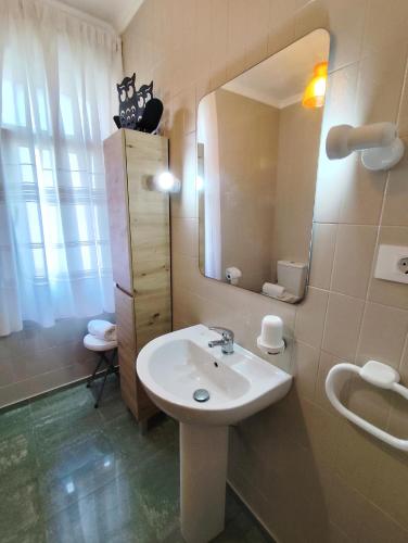 a bathroom with a sink and a mirror at Airtegal Litoral 49 Cedeira in Cedeira