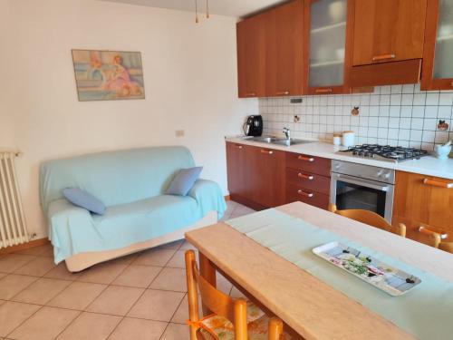 a kitchen with a couch and a table in a kitchen at Relax in Campagna in Due Cossani