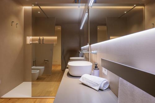a bathroom with two toilets and two sinks at Villa Amelia in Orta San Giulio