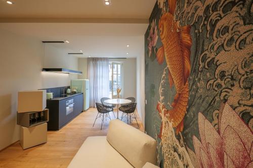 a living room with a koi painting on the wall at Villa Amelia in Orta San Giulio