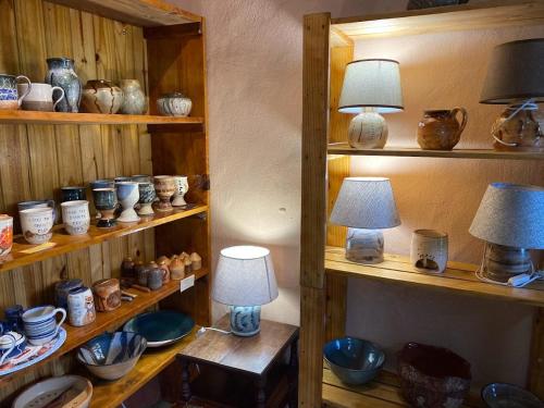 a room with shelves filled with vases and lamps at Sani Lodge & Cottages in Sani Pass