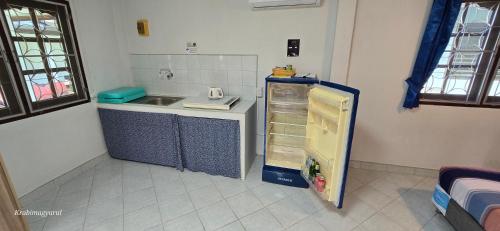 a small kitchen with a sink and a refrigerator at Sabai Resort in Ao Nang Beach