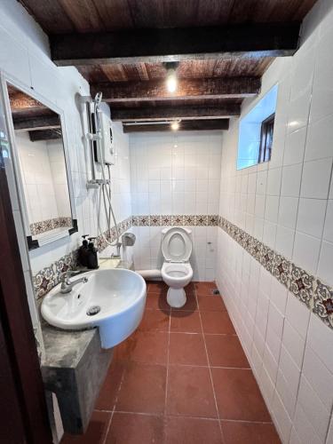 a bathroom with a white toilet and a sink at 26 Rangoon Residence 26 in George Town