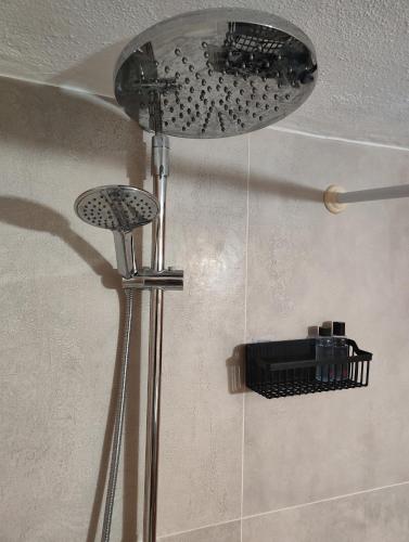 a shower with a shower head in a bathroom at Harmony Guest House in Pefkohori