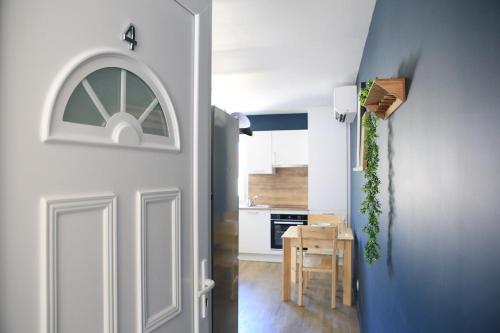 a door leading into a kitchen with a table and a kitchen at Superbe apartement T2 in La Celle-sous-Gouzon