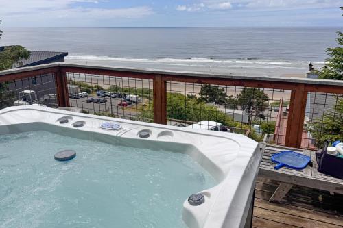 a hot tub on a balcony with a view of the ocean at Berni's Ocean View Castle - an Oceanside Legend in Oceanside