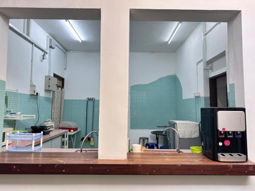 a room with a kitchen with a sink and a microwave at 26 Rangoon Residence 26 in George Town