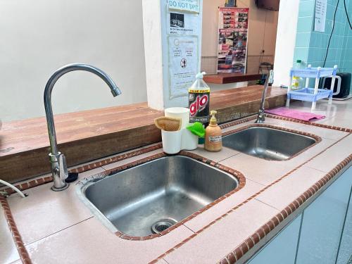 a kitchen counter with a sink in a kitchen at 26 Rangoon Residence 26 in George Town