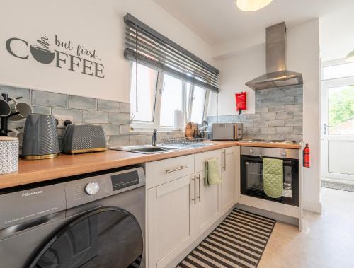 a kitchen with a washer and dryer in it at Urban Hideaway in Canwick