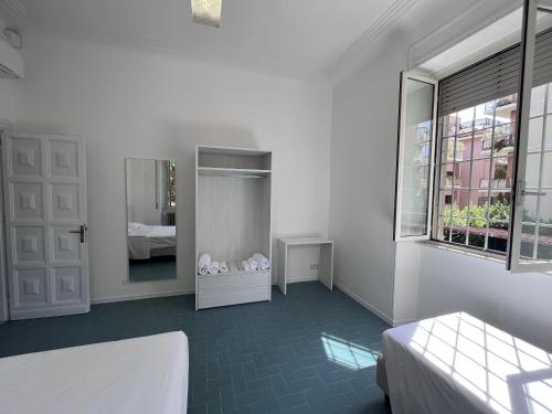 a white room with a bed and a mirror at Green Park San Pancrazio in Rome