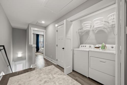 a kitchen with white cabinets and baskets on the wall at Rivers Edge - 111 Hickory Grove BLVD in Clarksville