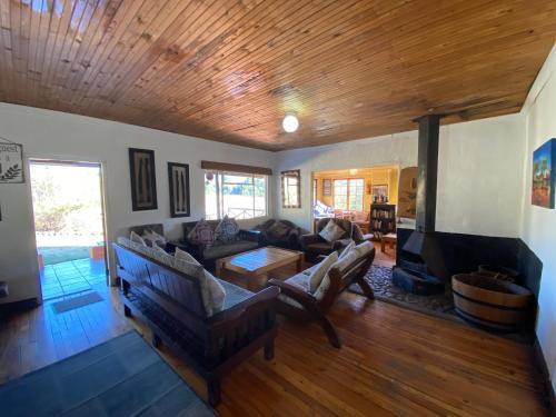 a living room with a couch and a fireplace at Sani Lodge & Cottages in Sani Pass
