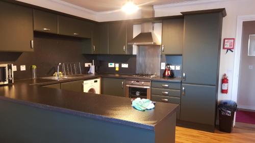 a kitchen with a counter top and a stove at Aber Holiday Rentals in Inverness