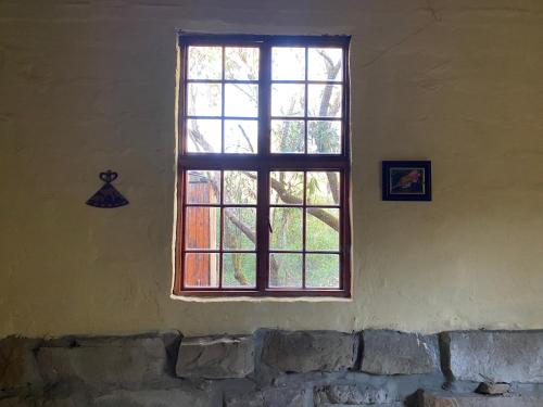 a window in the corner of a room at Sani Lodge & Cottages in Sani Pass