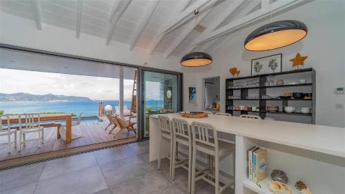 a kitchen with a view of the ocean at Four-Bedroom Sunset Villa with Infinity Pool in Pointe Milou