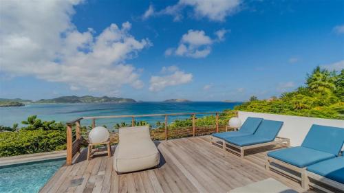 a view of the ocean from the deck of a villa at Four-Bedroom Sunset Villa with Infinity Pool in Pointe Milou