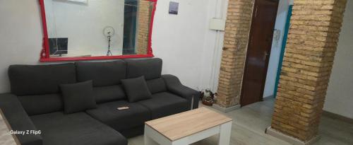 a living room with a couch and a mirror at Relax y bienestar in Valencia