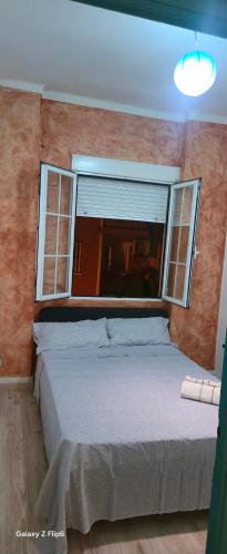 a bedroom with a large bed and a window at Relax y bienestar in Valencia