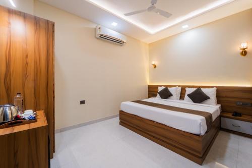 a hotel room with a bed and a desk at Hotel Kanha & Banquet in Mohāna