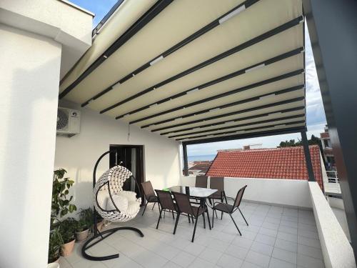 a patio with a table and chairs on a balcony at Apartments Radosevic in Ulcinj