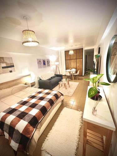 a bedroom with a bed and a living room at Marcelinos la perla in Mar del Plata