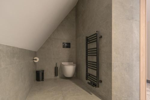 a bathroom with a toilet and a staircase at Wielka Krokiew Residence&SPA - Zakopane - JACUZZI, SAUNA, TĘŻNIA SOLANKOWA, SPA, GRILL in Zakopane