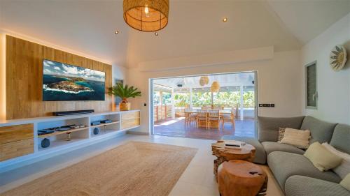 a living room with a couch and a table at St Jean Hilltop Three-Bedroom Villa with Pool in Gustavia