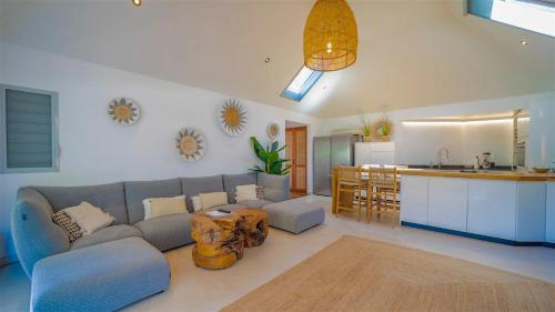 a living room with a couch and a kitchen at St Jean Hilltop Three-Bedroom Villa with Pool in Gustavia