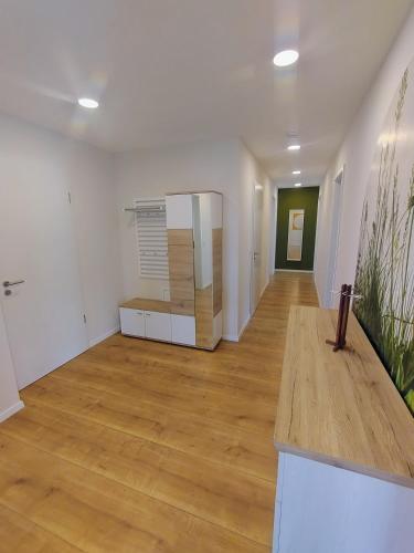 an empty room with white walls and wooden floors at Ferienwohnung Frauenberg in Bad Waldsee