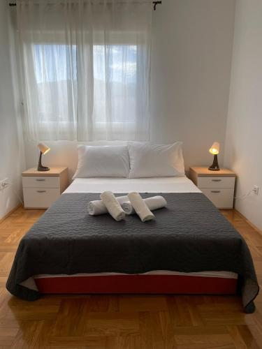 a bedroom with a bed with two towels on it at Apartment Sara in Solin
