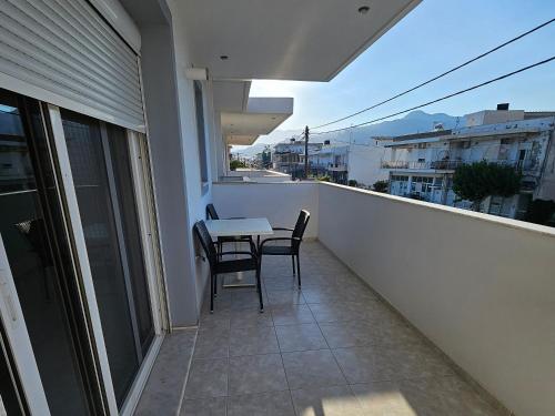 a balcony with a table and chairs on a balcony at Poppis Home in Ierápetra