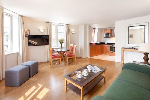 a living room with a couch and a table at Marlin Apartments London City - Queen Street in London