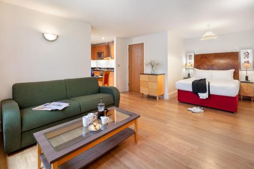 a living room with a couch and a bed at Marlin Apartments London City - Queen Street in London