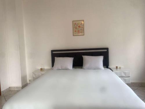 Ένα ή περισσότερα κρεβάτια σε δωμάτιο στο Cosy 50m de la Mer avec Parking privé