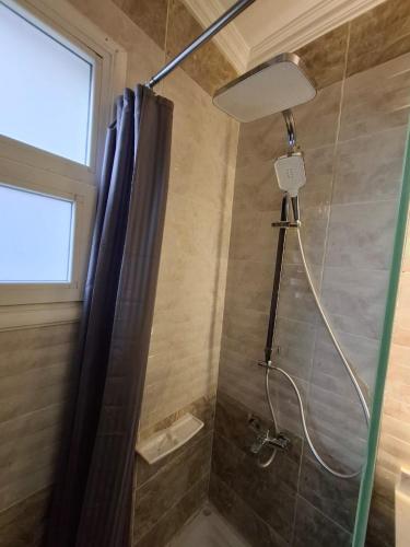 a bathroom with a shower with a shower curtain at Modern City Apartment in Cairo