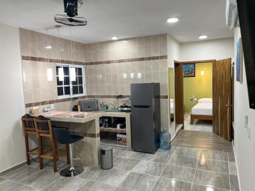 a kitchen with a sink and a refrigerator at Depa Caribe III in Bacalar
