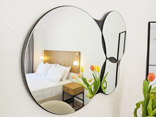 a mirror in a hotel room with a bed at L'Ora Blu in Marathokampos