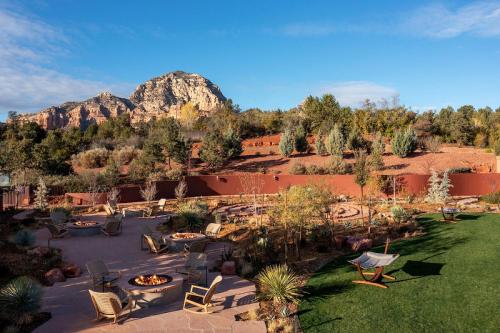 an outdoor patio with chairs and a fireplace with a mountain at The Wilde Resort and Spa in Sedona