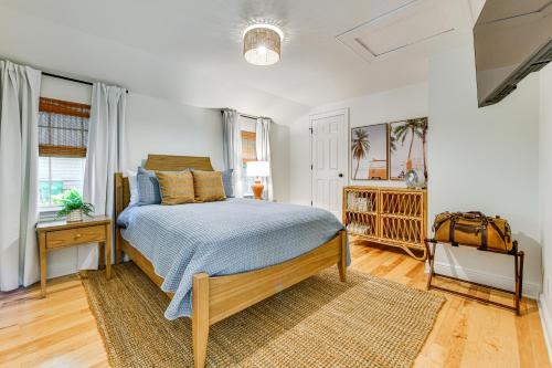 a bedroom with a bed with a blue comforter at Home 2 Mi to Beach and Old Town Bay St Louis! in Bay Saint Louis