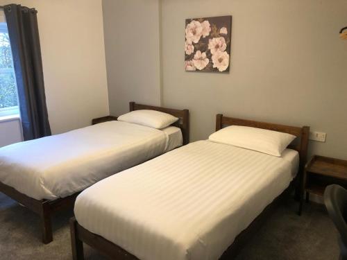 Ένα ή περισσότερα κρεβάτια σε δωμάτιο στο Abbeyfield Guesthouse