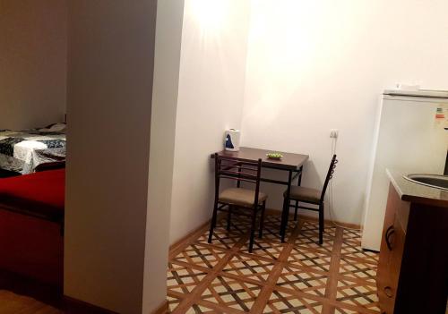 a small room with a small table and two chairs at Guest House Villa in Kvareli